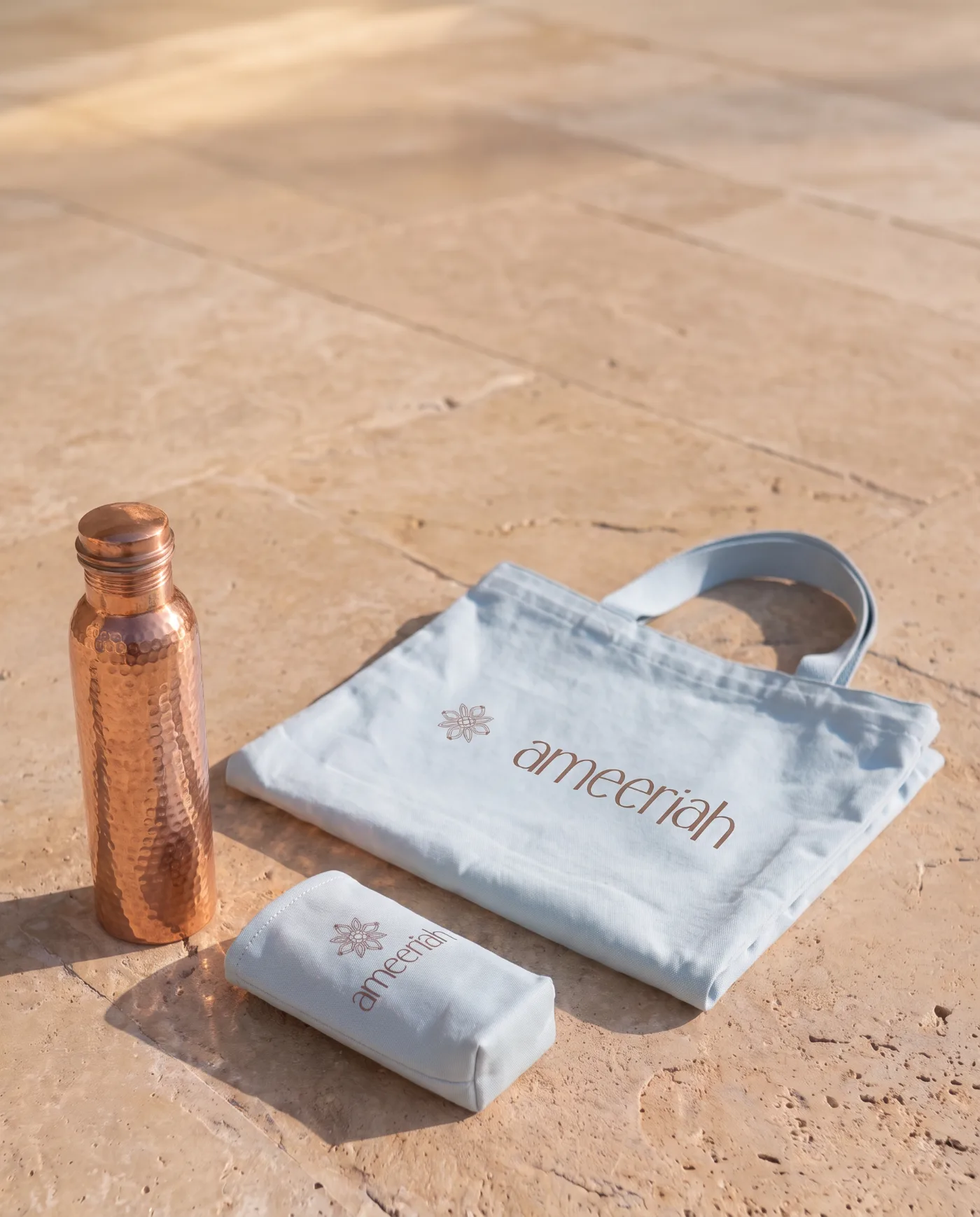 Raj Prana: copper bottle, large tote and small bottle tote on travertine